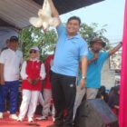 Camat Binuang Kabupaten Serang Mamak Abror menunjukkan hadiah ayam kepada peserta.